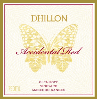A label of Dhillon Accidental Red wine featuring a golden butterfly design over a cream background, with text including the wine name, vineyard location, and volume of 750ml.