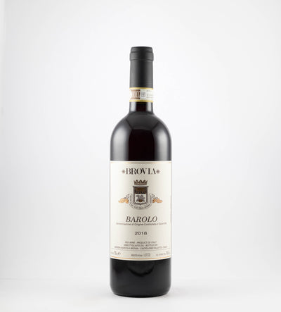 A bottle of 2020 Brovia Barolo wine with a white label and gold accents on a clear background.