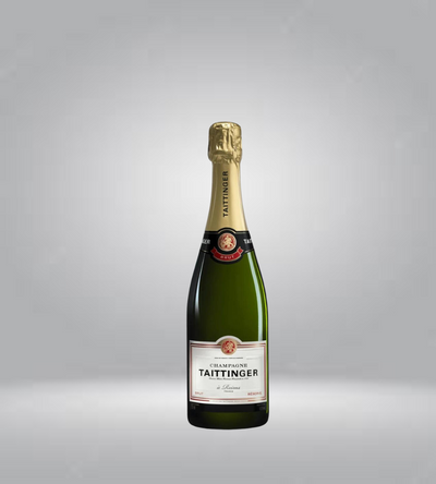 A bottle of NV Taittinger Brut Reserve Champagne with a golden foil cover on top and a label that includes the brand name and vintage.